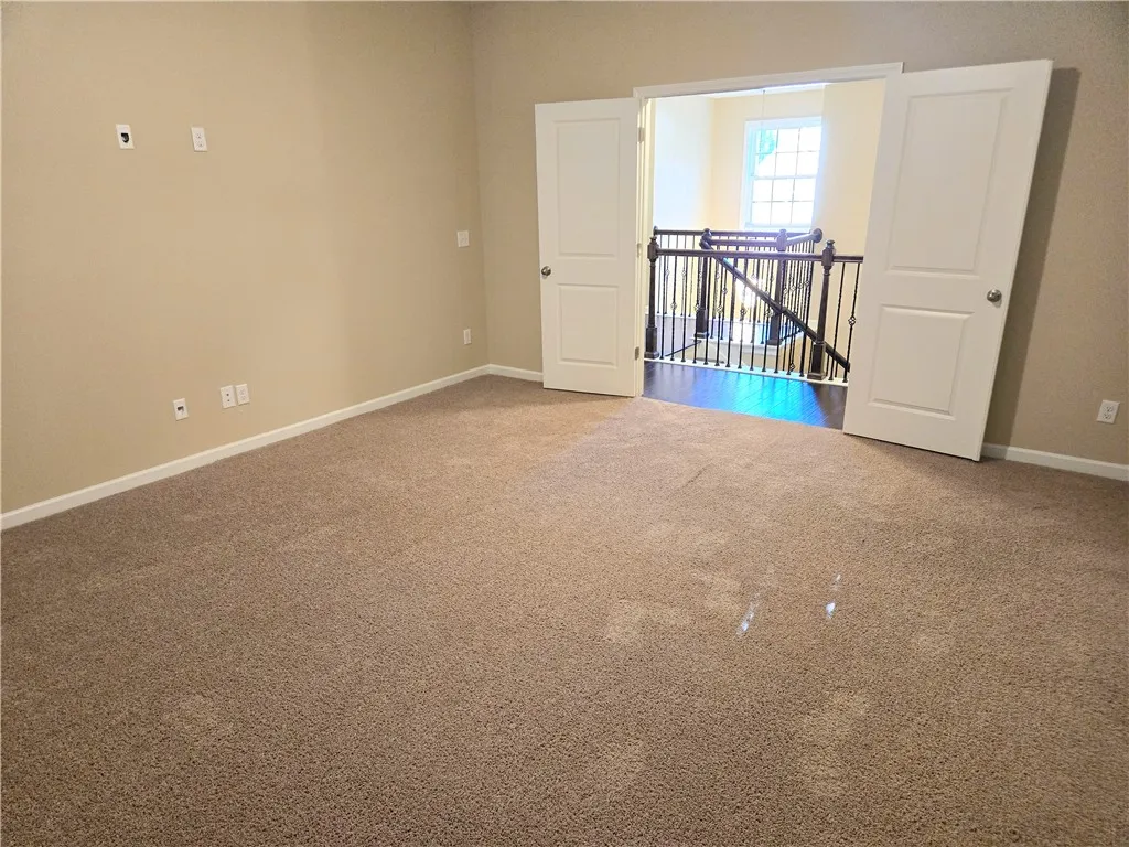 A versatile bonus room awaits, offering ample space and direct access to the elegant staircase.