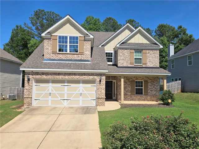 A classic brick exterior with a welcoming covered porch, offering appealing curb appeal.