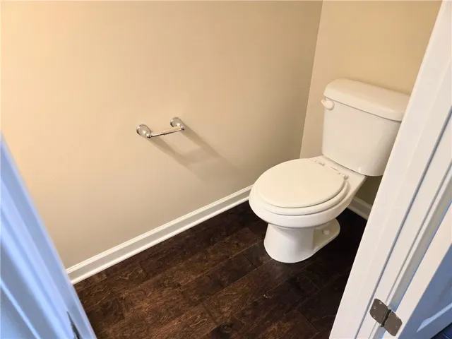 A well-maintained commode offers convenience in this discreetly appointed space.