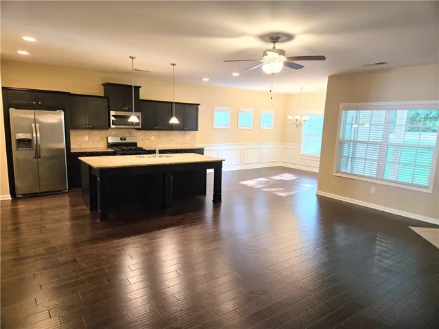 An open concept kitchen with a central island and a contiguous dining area, perfect for entertaining.