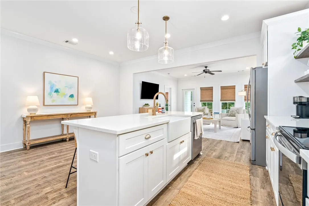 A seamless open floorplan connects the contemporary kitchen to a luminous living space.