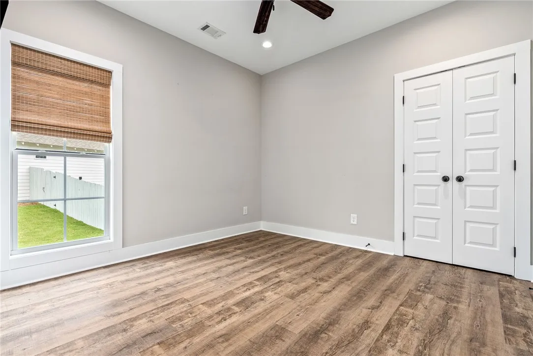 Hardwood-style flooring and a window with natural light create a peaceful interior space.