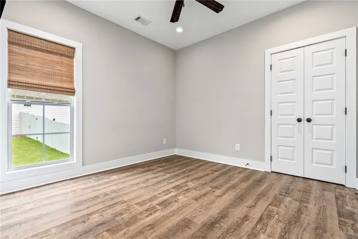 Hardwood-style flooring and a window with natural light create a peaceful interior space.