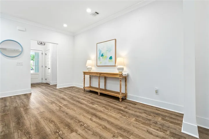 A welcoming entry space with wide plank flooring extends an inviting charm.