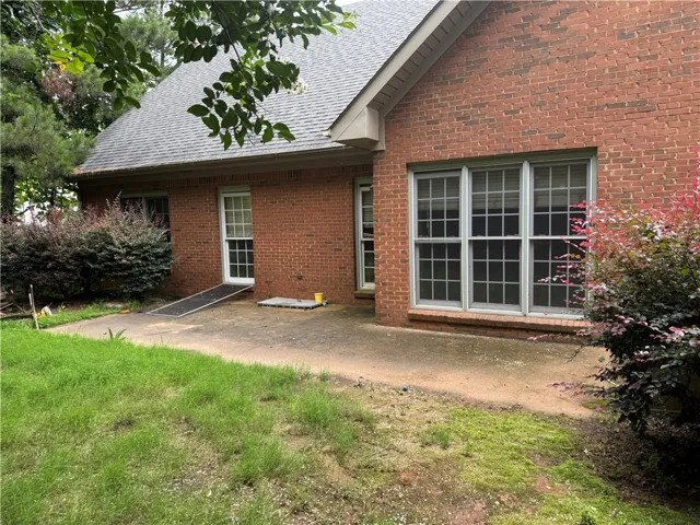 A classic brick exterior offers generous windows and mature, vibrant landscaping.