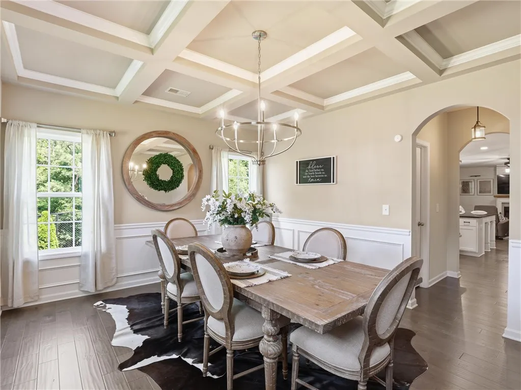 Ornate coffered ceilings crown this formal dining area, ready for memorable meals and entertaining.