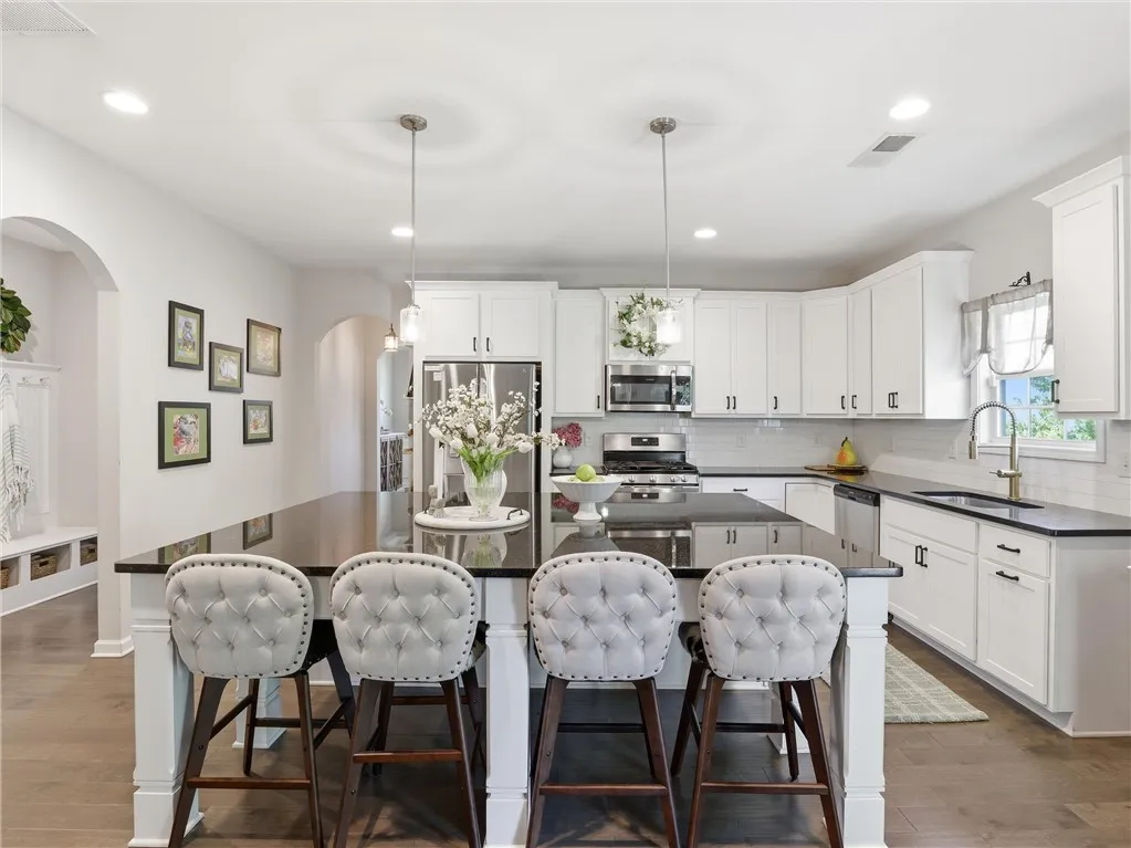 A well-appointed kitchen features a spacious island with seating, ideal for gathering and meal preparation.