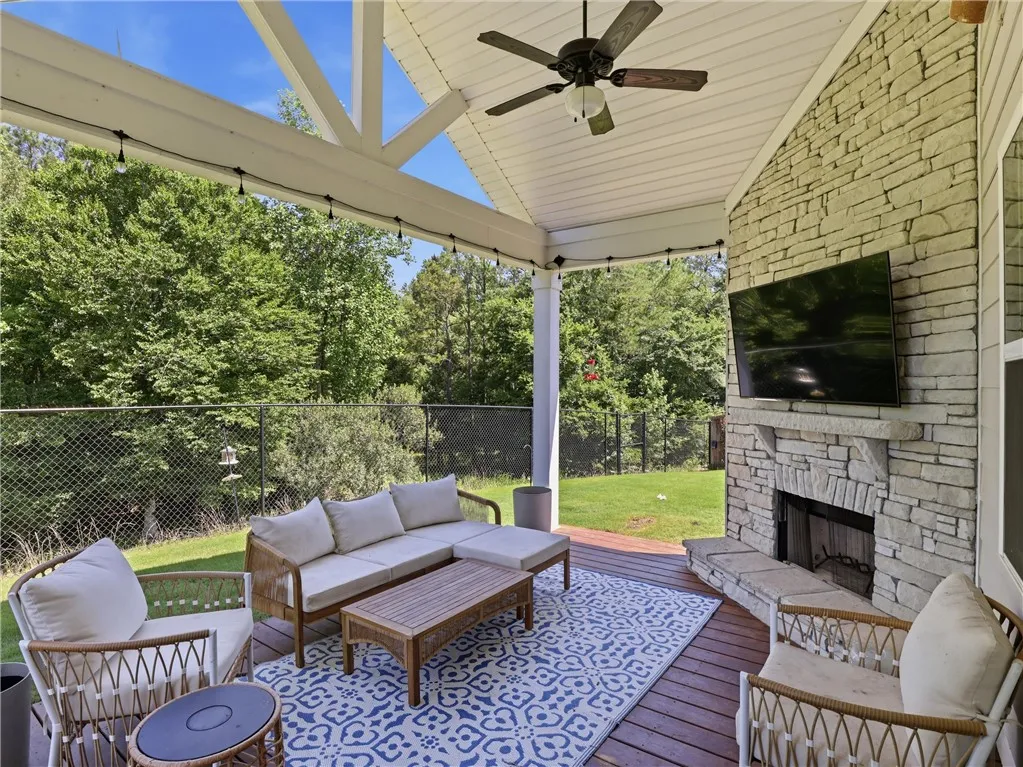 An inviting outdoor living area awaits, complete with a cozy fireplace for relaxed gatherings.