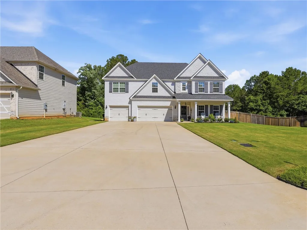 A well-maintained two-story residence with a classic facade and ample driveway space.