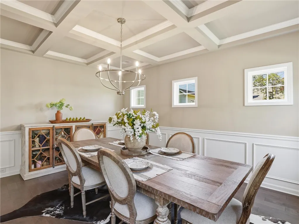 Elegant coffered ceilings crown this formal dining area, ready for memorable gatherings.
