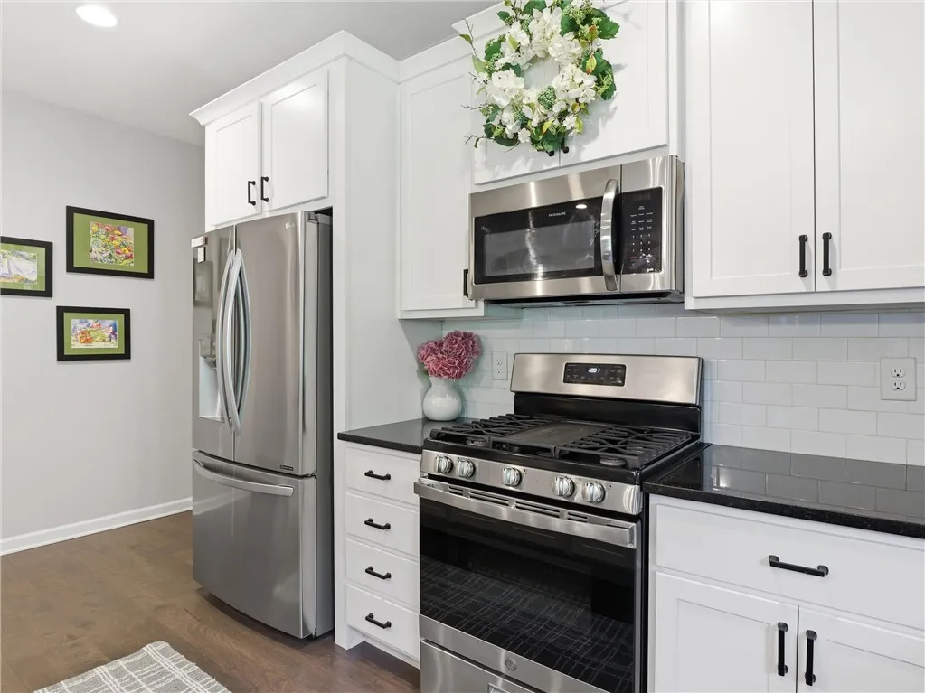 A well-appointed kitchen showcasing contemporary appliances and pristine cabinetry.