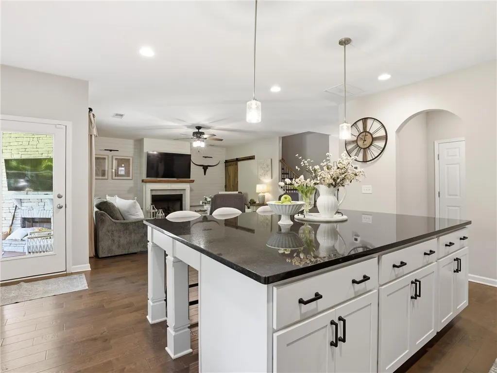 An inviting open-concept space features a well-appointed kitchen island, perfect for entertaining.