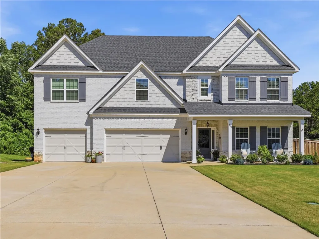 A classic facade showcasing a welcoming front porch and ample parking.