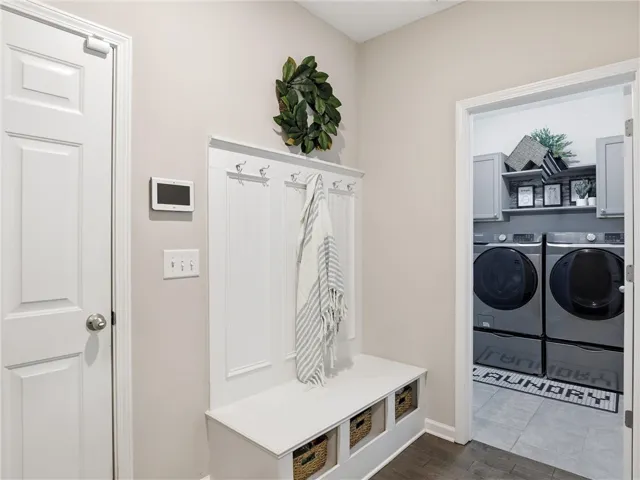 Functional mudroom with convenient built-in seating and hooks, leading to a dedicated laundry area.