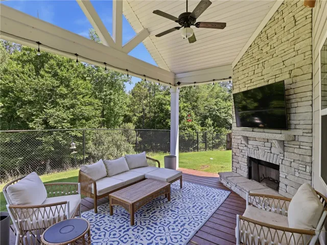 An inviting outdoor living area awaits, complete with a cozy fireplace for relaxed gatherings.