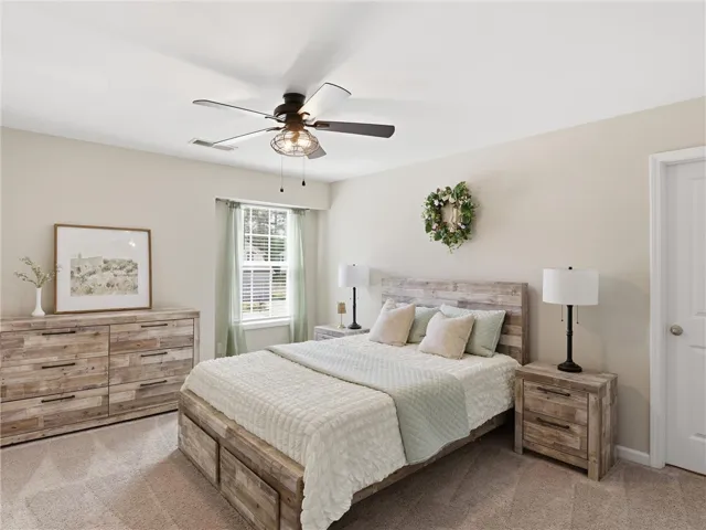 Relax in this peaceful bedroom retreat, featuring a window and carpeted floors.