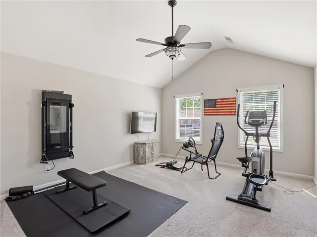 Fitness retreat, featuring high vaulted ceilings and ample room for varied workout equipment.