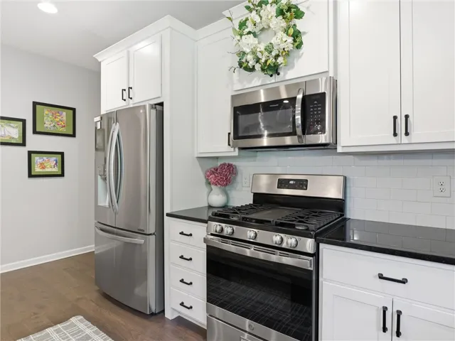 A well-appointed kitchen showcasing contemporary appliances and pristine cabinetry.