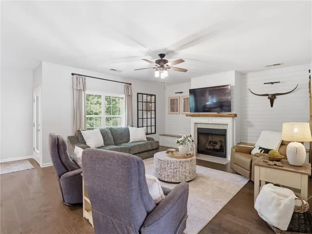 A welcoming living area featuring rich hardwood floors and a cozy fireplace, perfect for gatherings.