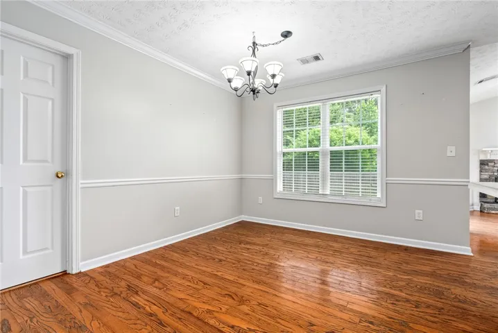 Hardwood floors and ample natural light define this inviting dining area.