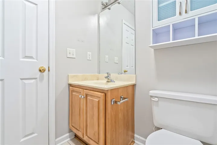 Functional vanity and storage cabinet provide essential amenities for this hall bath.