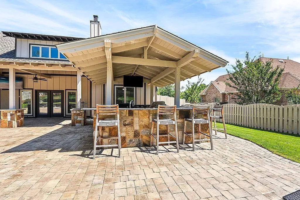 An inviting outdoor kitchen with a stone-clad bar, perfect for alfresco dining and entertaining.