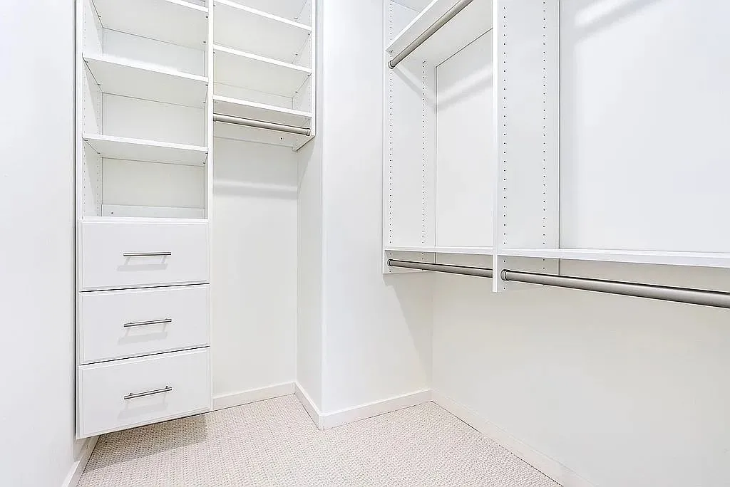 Streamlined organization awaits in this well-appointed walk-in closet, maximizing storage potential.