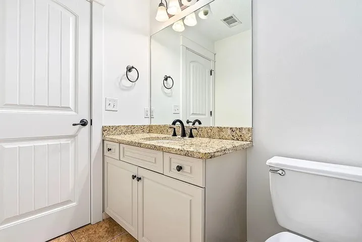 A well-appointed bathroom with a spacious vanity and elegant granite countertops.