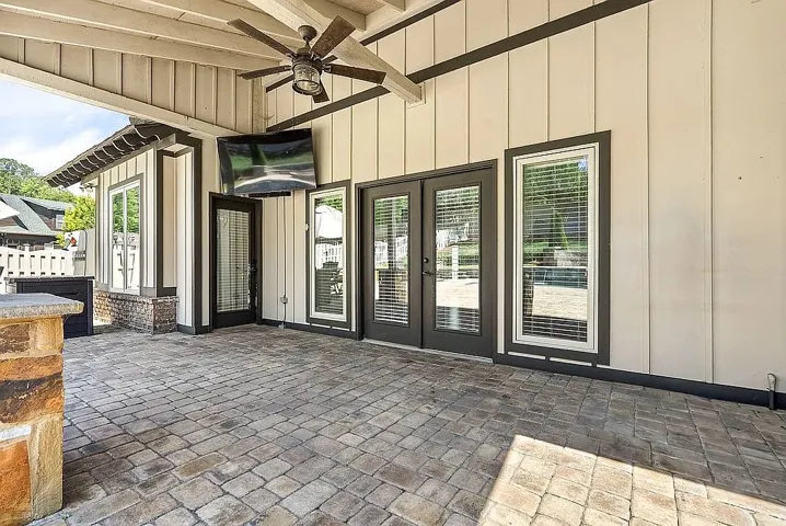 An inviting outdoor patio features elegant paver flooring, offering a perfect space for relaxation and entertainment.
