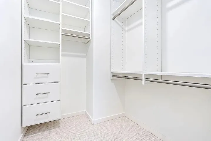 Streamlined organization awaits in this well-appointed walk-in closet, maximizing storage potential.