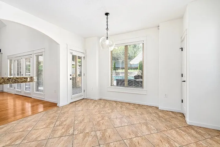 A well-lit breakfast nook with access to the outdoors offers a tranquil start to any day.