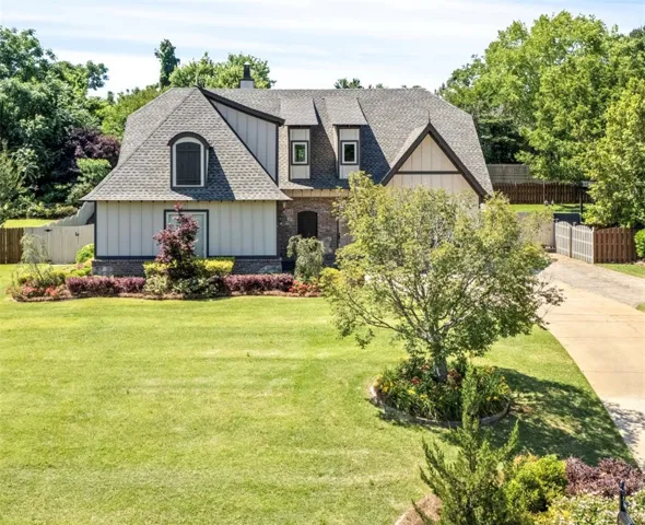 A classic facade with charming dormers and lush landscaping welcomes you home.