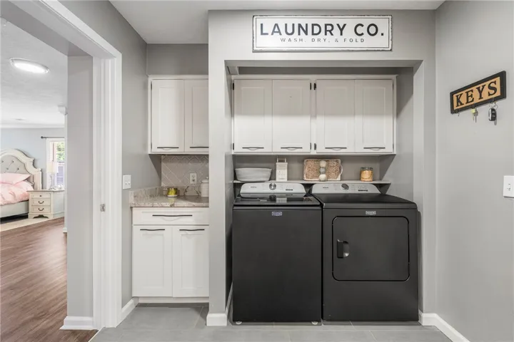 Functional laundry space featuring modern appliances and ample storage.