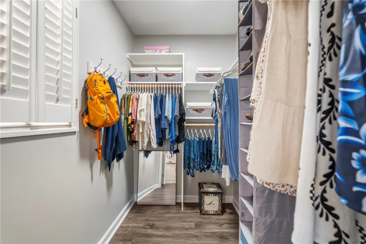 Well-organized walk-in closet with ample storage, featuring convenient shelving and hanging space.