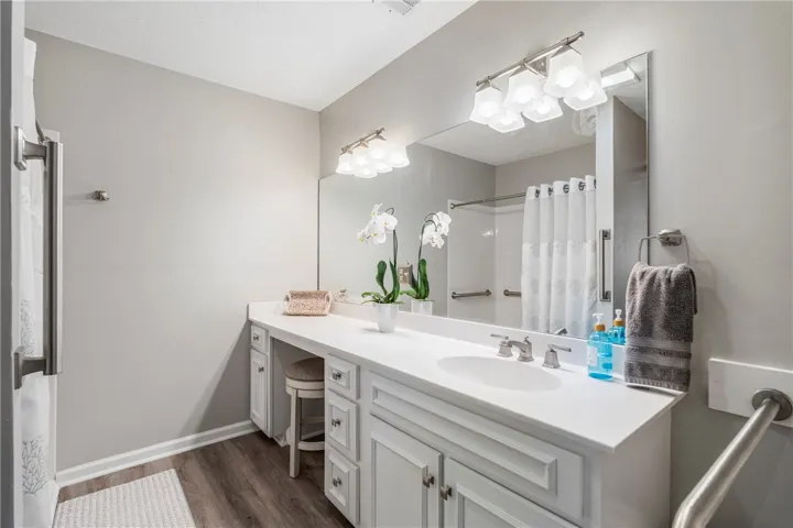 A well-appointed bathroom offers a vanity with ample counter space and a large mirror.