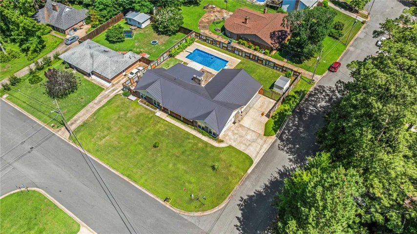 An aerial perspective reveals a private pool with ample surrounding green space, offering a tranquil retreat.