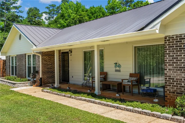 A well-maintained brick and siding facade welcomes visitors with a charming covered porch and thoughtful landscaping.