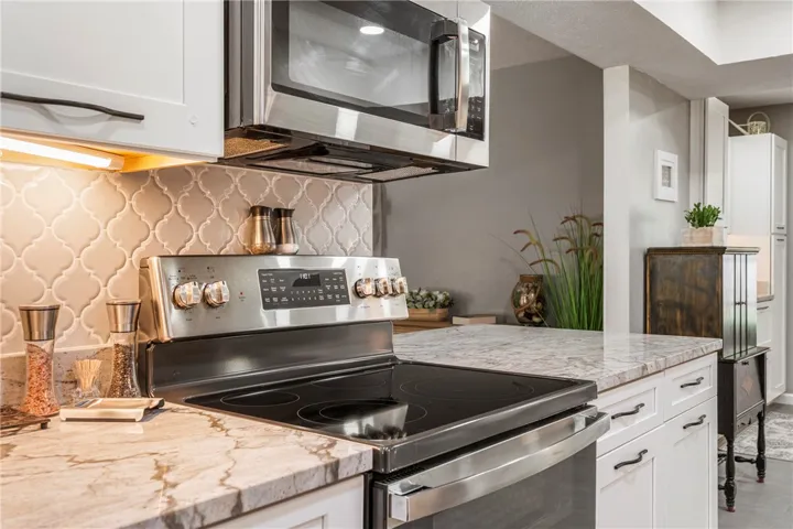Stainless steel appliances and richly veined countertops define this contemporary kitchen's appeal.
