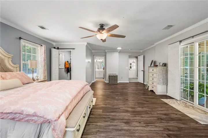 Ample space for relaxation with rich wood flooring and direct outdoor access.