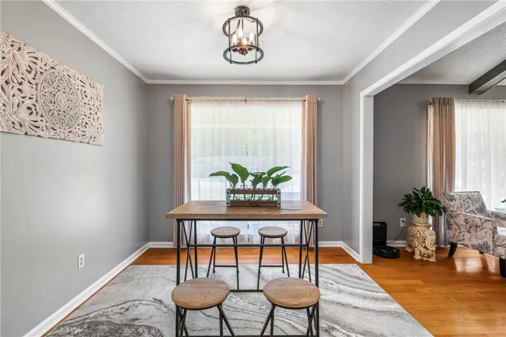 Hardwood floors and crown molding elevate this welcoming dining area, perfect for intimate gatherings.