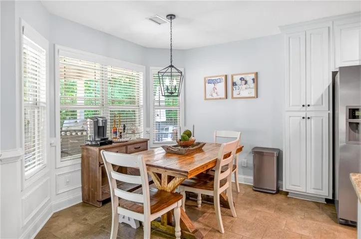 Enjoy casual meals in this sun-filled eat-in kitchen with plentiful cabinet storage.