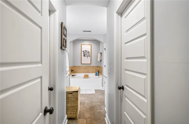 A well-appointed bath offers a serene escape, featuring a deep soaking tub and elegant tile accents.