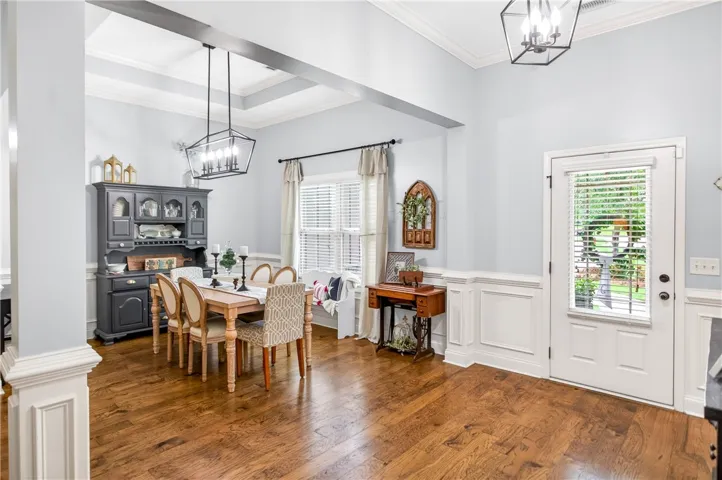 Rich hardwood floors complement tray ceilings in this elegant dining area.