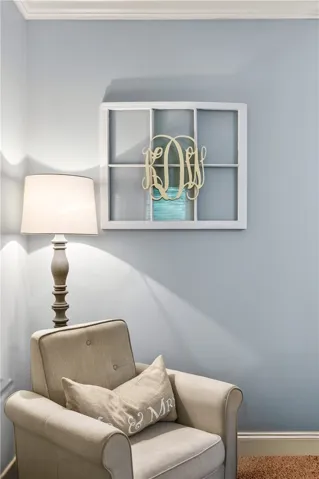 A comforting armchair awaits next to a decorative window accent in this welcoming interior space.