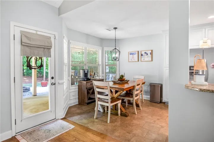 An inviting dining area flows seamlessly from the kitchen, offering casual elegance.