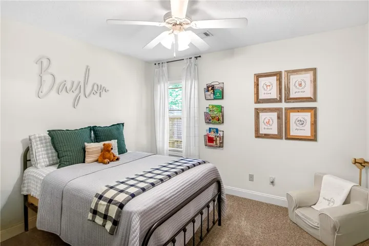 A well-lit room featuring a comfortable bed and natural light through the window.