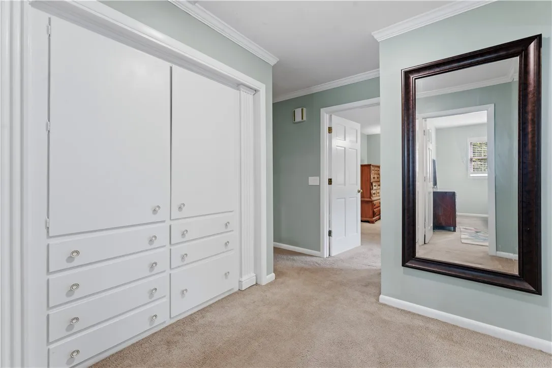 A well-organized hallway provides convenient storage solutions with integrated cabinetry.