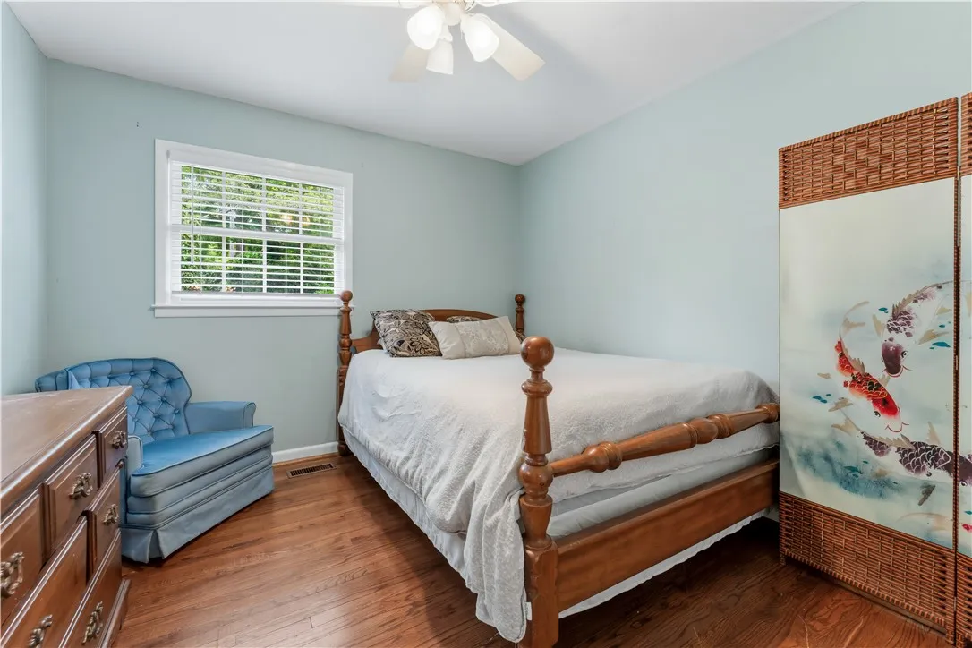 A comforting bedroom with hardwood floors offers a tranquil retreat.