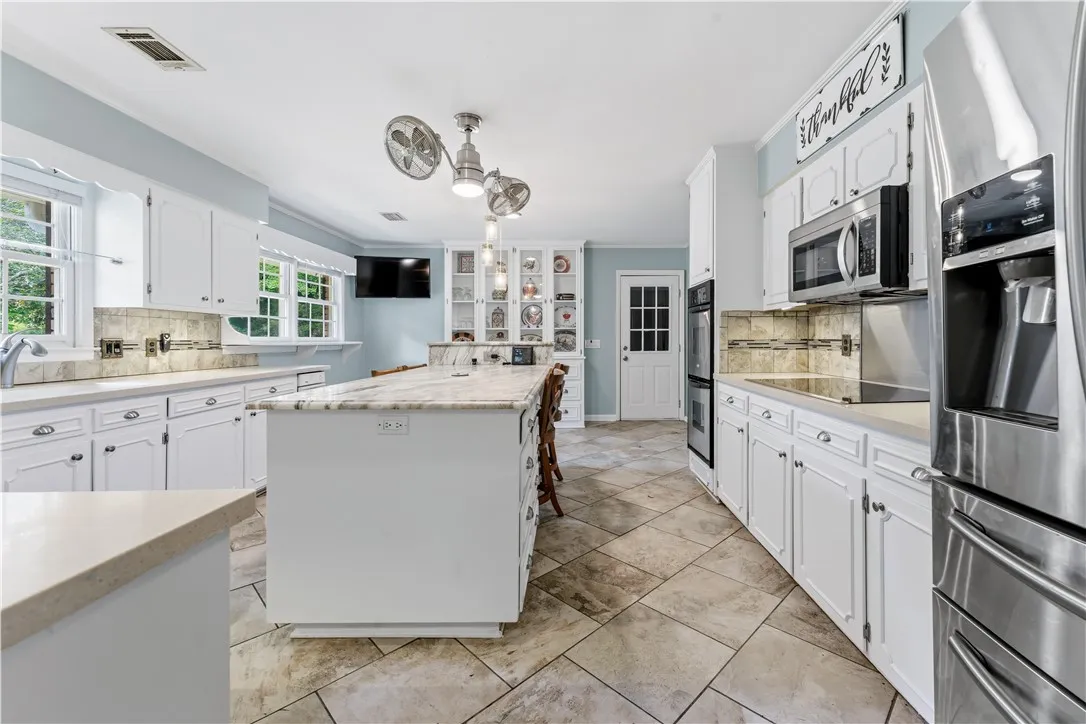 Culinary dreams come alive in this kitchen, featuring an expansive island with ample counter space.