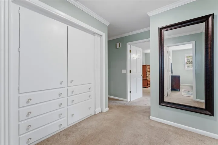 A well-organized hallway provides convenient storage solutions with integrated cabinetry.
